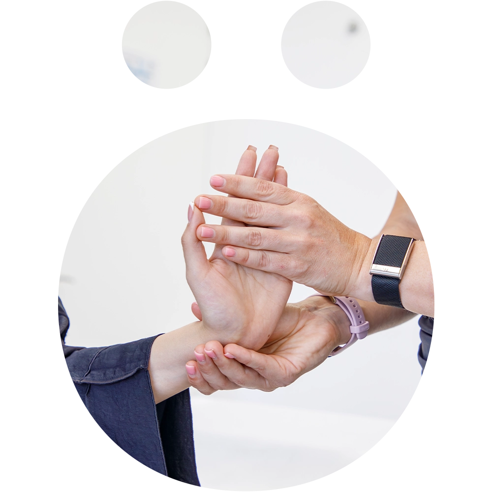Physiotherapist guiding a patient through wrist and hand exercises at Sno Clinics Abu Dhabi to reduce pain and improve movement - Snö Clinics | Abu Dhabi Physiotherapist guiding a patient through wrist and hand exercises at Sno Clinics Abu Dhabi to reduce pain and improve movement.
